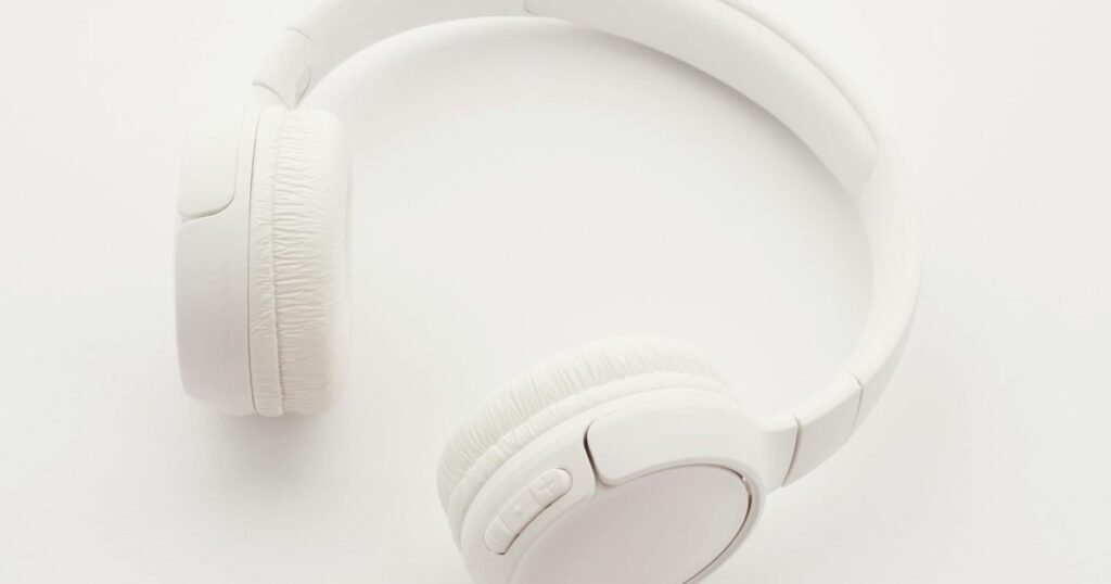 Person listening to Spanish podcasts with headphones