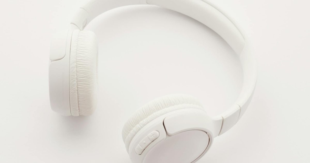 Person listening to Spanish podcasts with headphones
