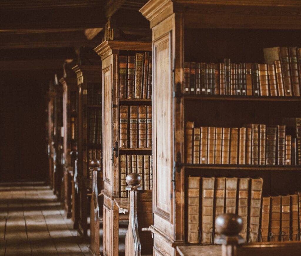 Old library with tall labyrinth-like bookshelves, evoking Jorge Luis Borges and the Library of Babel
