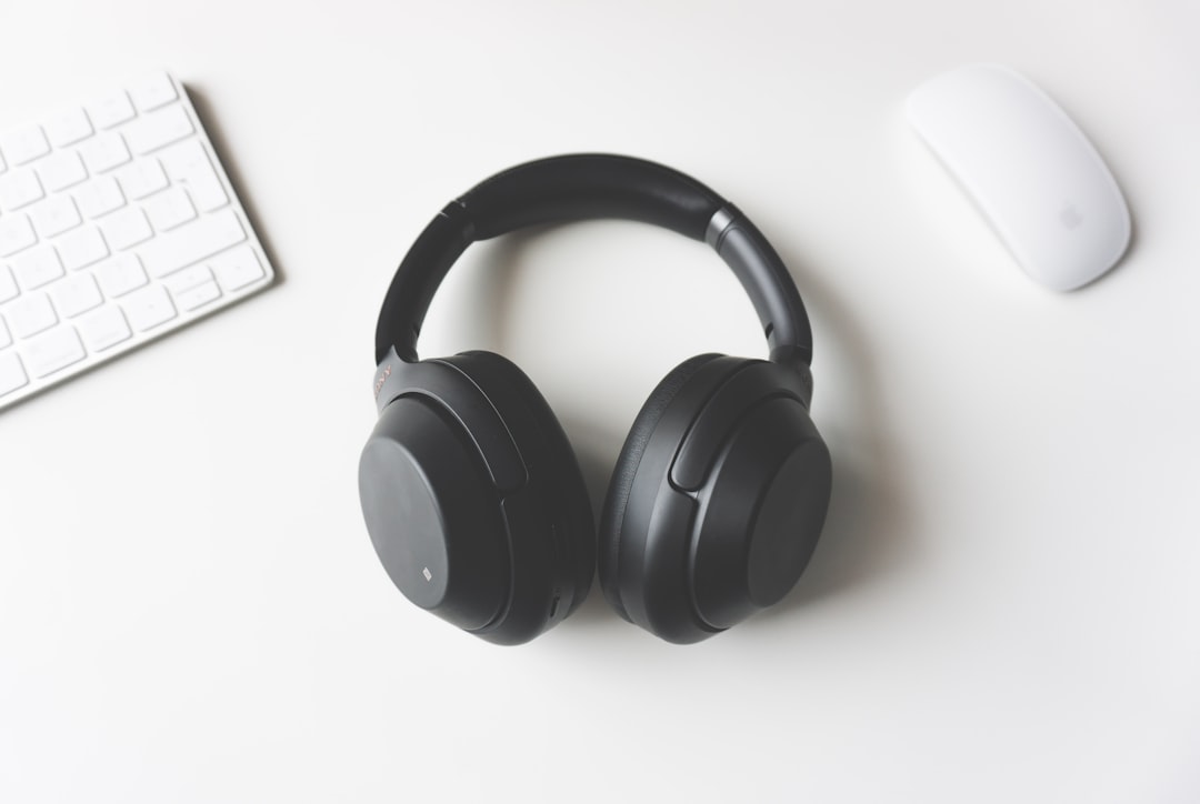 A laptop and headphones on a desk, set up for watching Spanish lessons