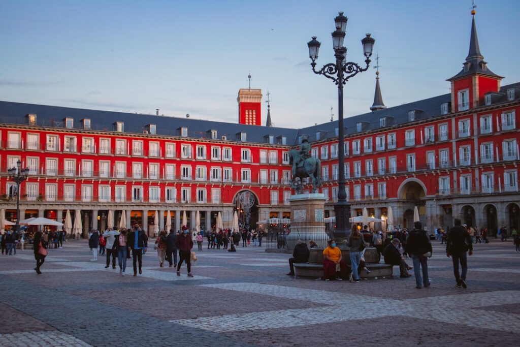Evening terrace tables on a busy Madrid plaza where locals chat over drinks