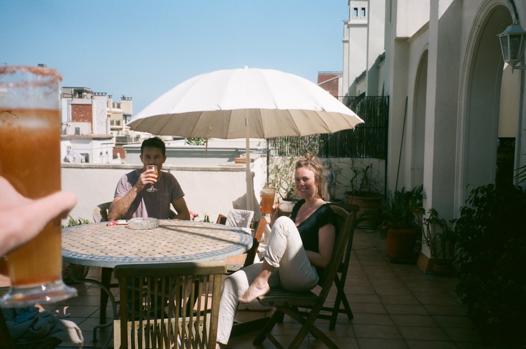 Friends lingering in conversation around a long lunch table, the Spanish sobremesa in action