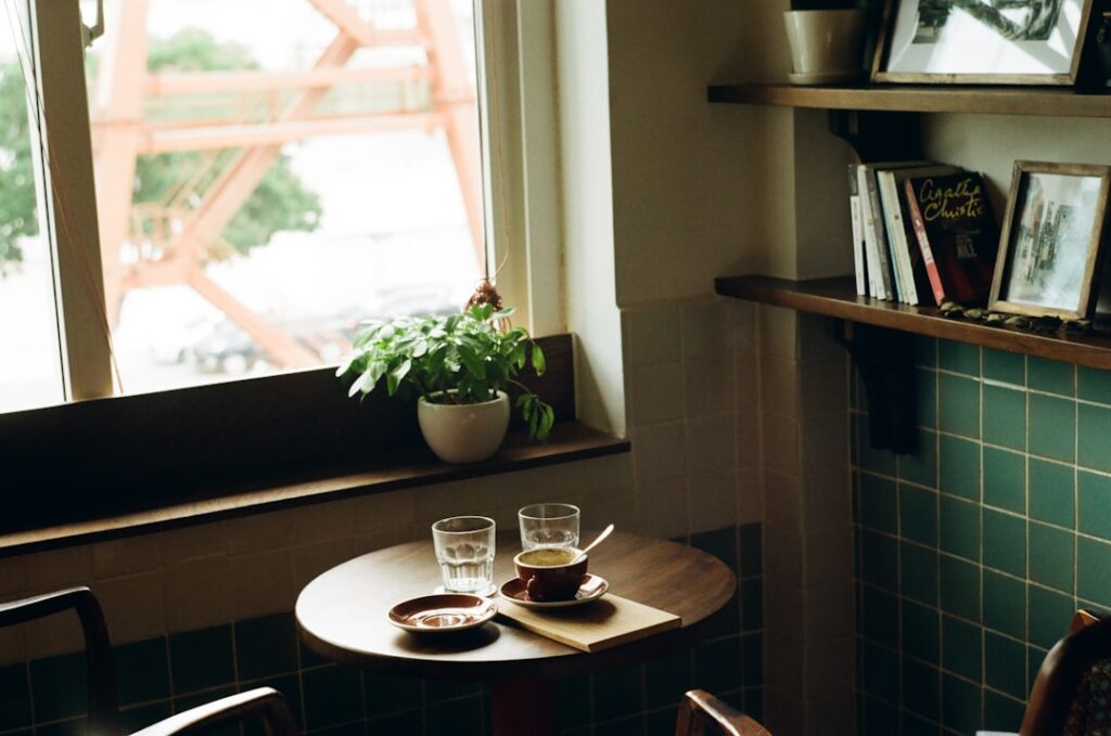 Reading a book by a cafe window in the morning light