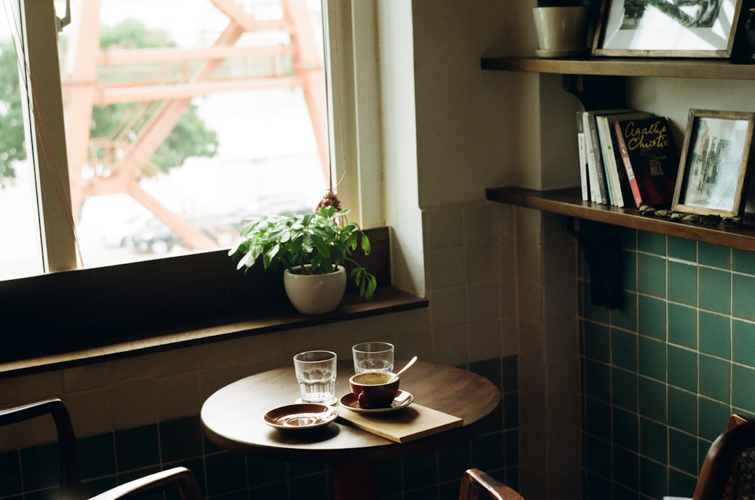 Reading a book by a cafe window in the morning light