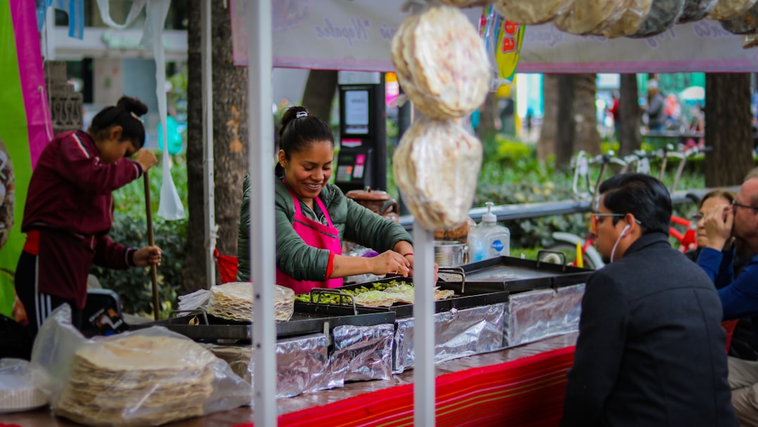 People talking on a busy Mexico City street in the afternoon