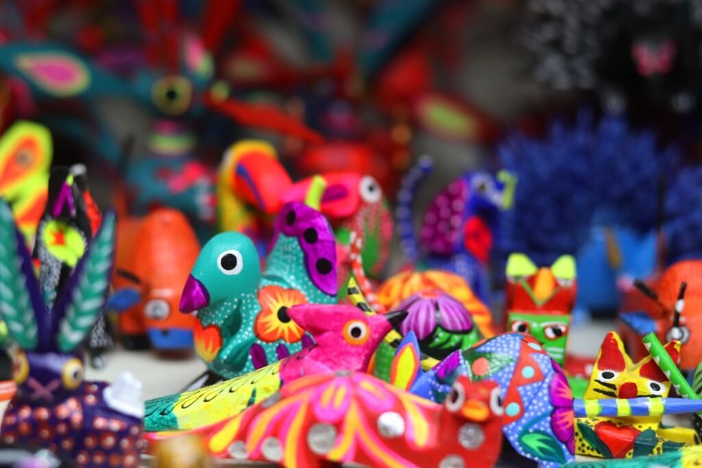 Brightly painted wooden alebrije animal figures on a market stall in Oaxaca