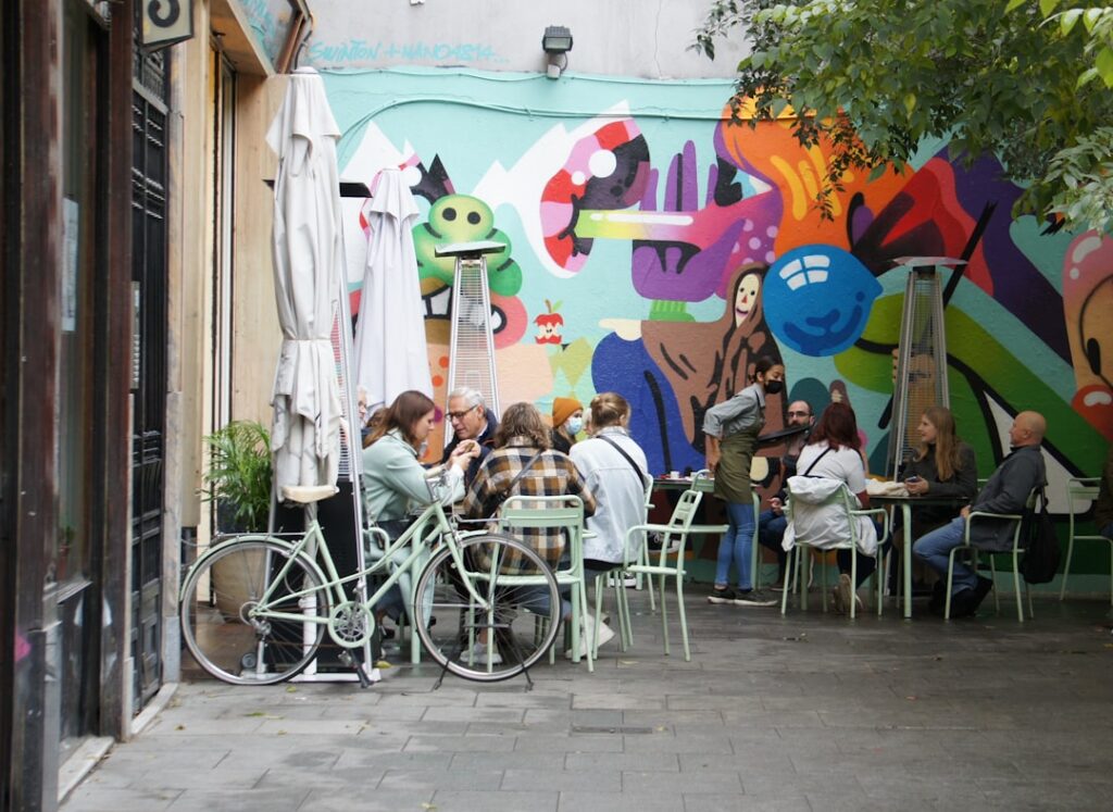 Friends arranging to meet at a cafe table in Madrid