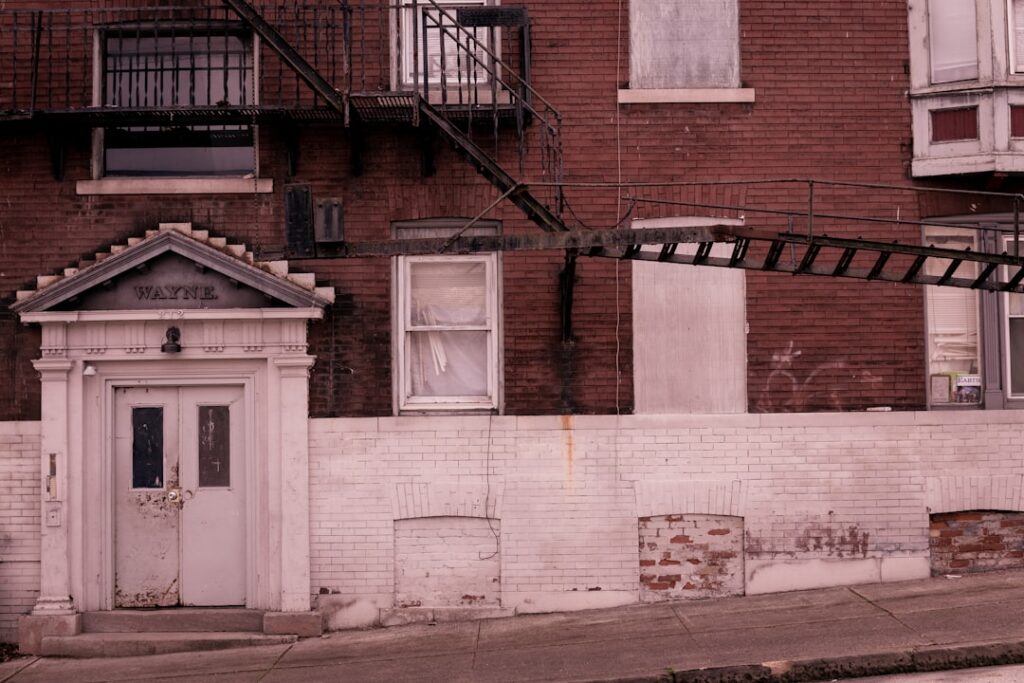 Two neighbours greeting each other in an apartment building doorway