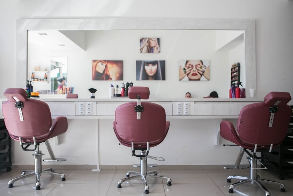 A hairdresser cutting a client's hair in a salon chair