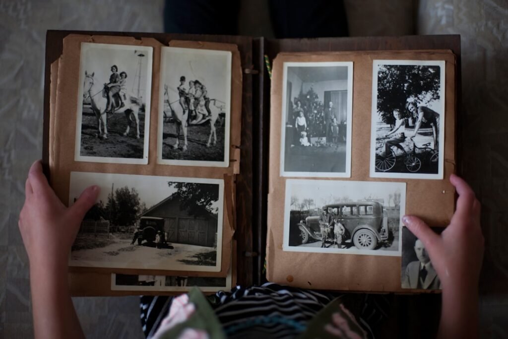 A box of old family photographs, standing in for the Spanish two-surname system that keeps both parents on the record.